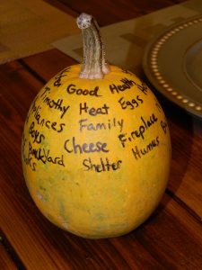Thankful Pumpkin/Thankful Squash with words of gratitude written on it, including "Heat, Eggs, Shelter, Fireplace, Cheese"