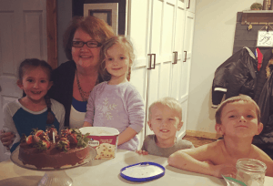 Grandma with grandkids, showing the qualities of a good mother.
