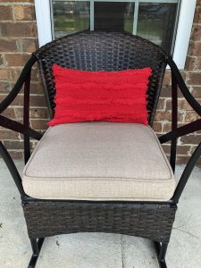 red throw pillow cover on porch chair