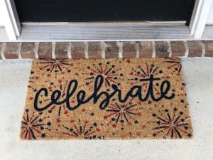 patriotic welcome mat that reads "celebrate" with firework design