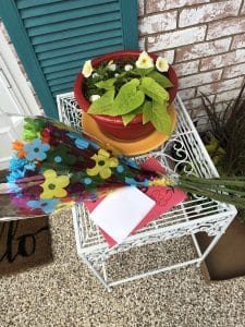 bouquet of flowers and a card on a porch