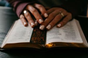 woman's hands resting on an open bible