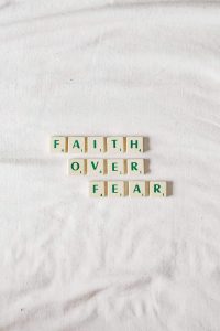 letter tiles spelling the words "Faith over Fear"