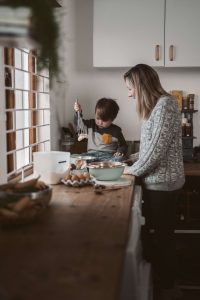 Homemaker in kitchen with son baking together