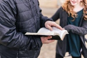 parent reading scripture with tween daughter