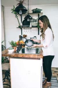 Homemaker washing dishes at the sink