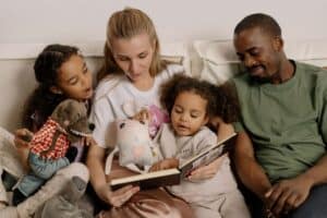 family of four snuggling together and doing family devotions