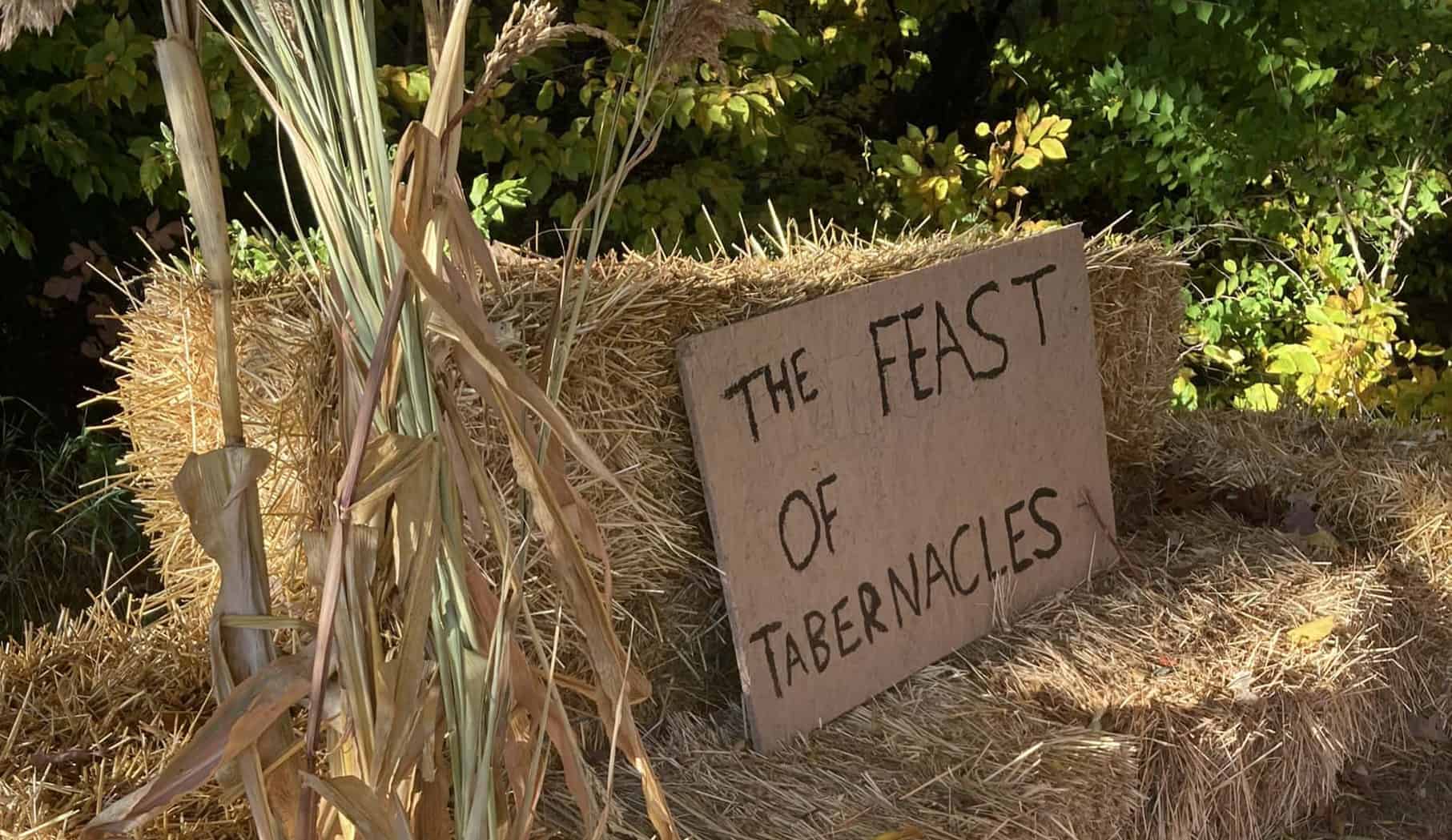 A hand written sign "The Feast of Tabernacles" set on bails of hay