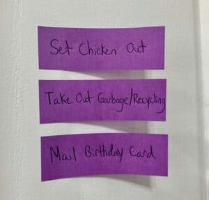 Post it notes stuck to wall- Great tool for busy moms trying to remember daily tasks