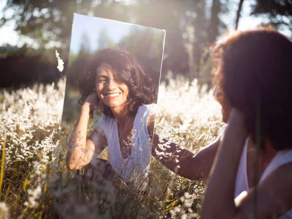 Woman in mirror happy with herself