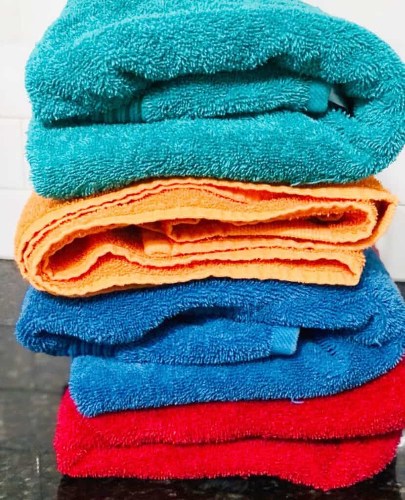 Laundry hacks for busy moms:
Rewear and reuse what you can.

(photo of a stack of folded towels in different colors)