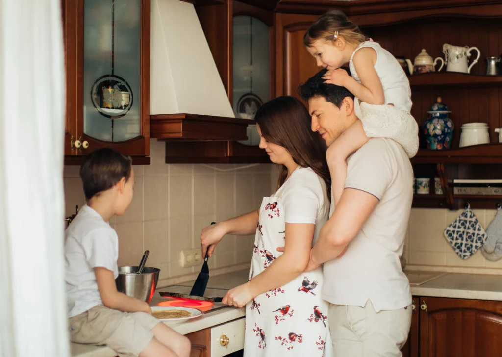 Family cooking in kitchen together for slow homemaking