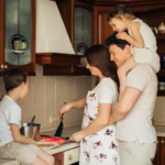 Family cooking in kitchen together for slow homemaking
