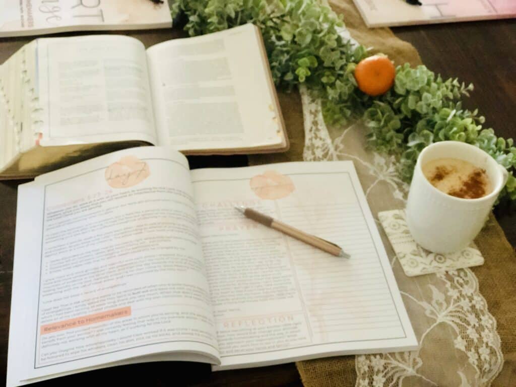 Heart Change for Homemakers devotional, open on a table with a cup of coffee and an open bible