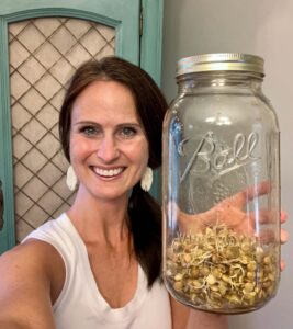 woman holding jar of sprouted lentils