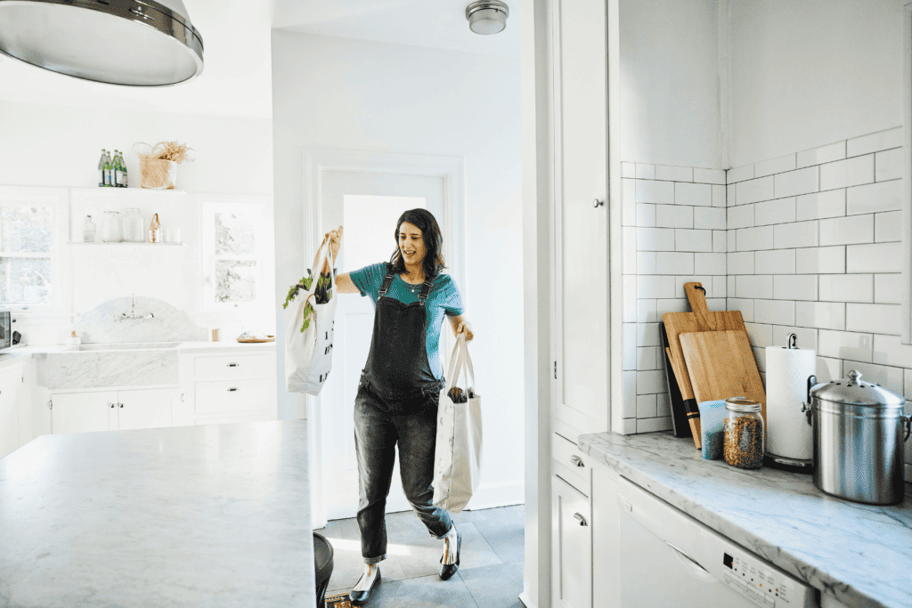 How homemakers can serve others: Run errands. (woman bringing in groceries)