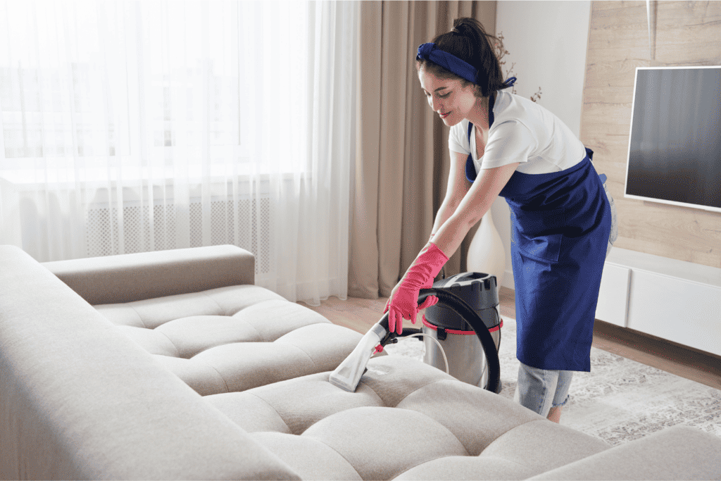 Woman vacuuming because she has a cleaning schedule