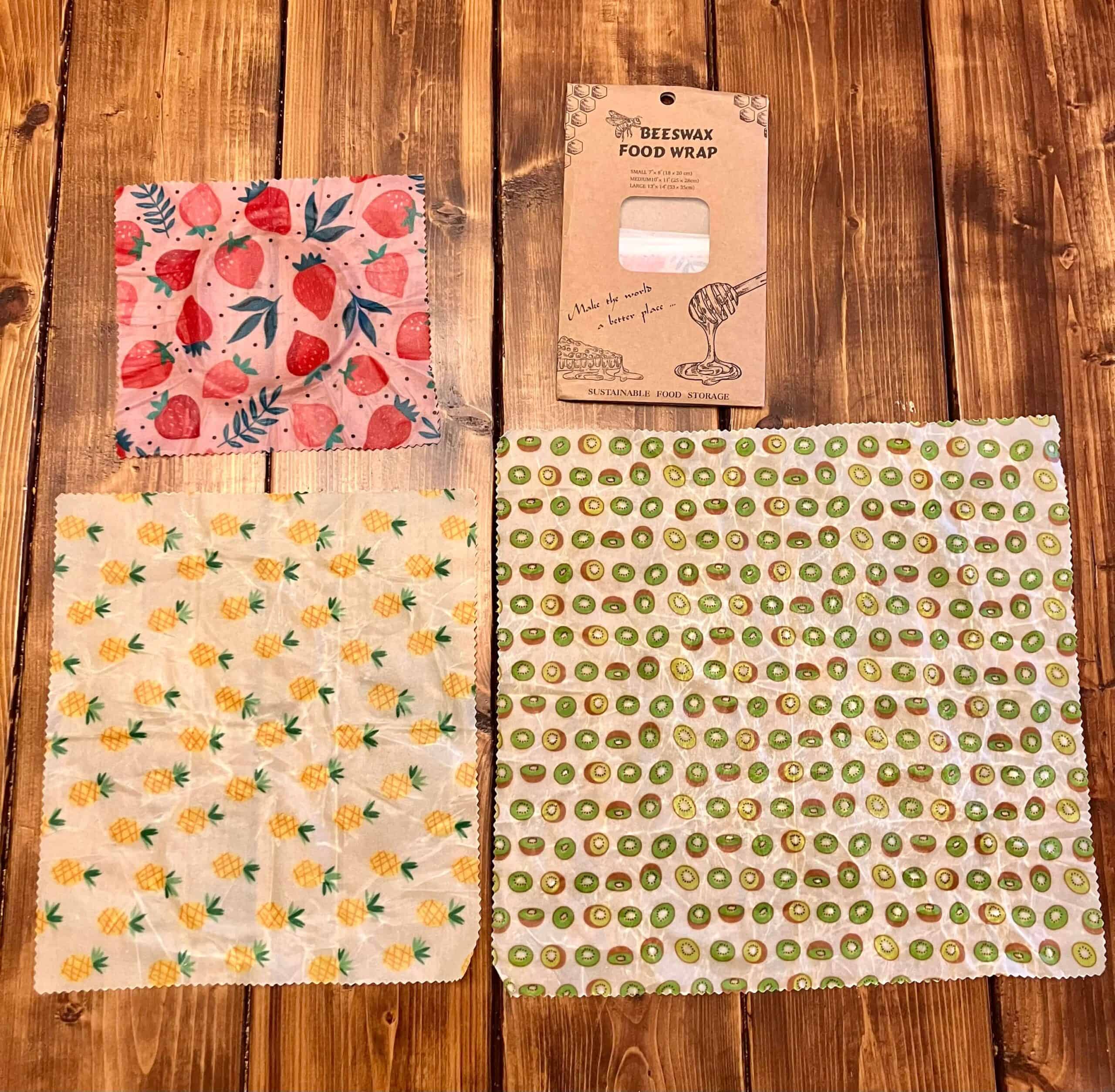 Beeswax wraps laying on a table in sizes small, medium, and large
