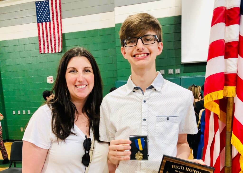 What no one tells you about raising teen boys: They appreciate your input, but don't want long-winded answers. (Mom and teen son at an awards banquet.)