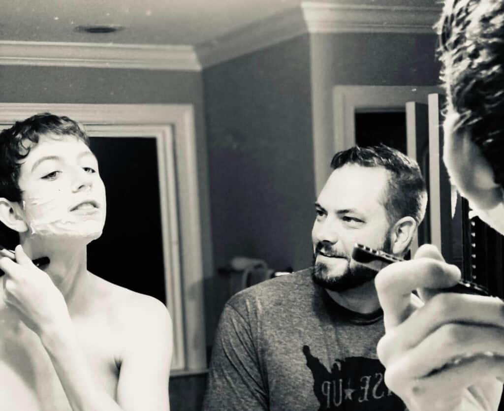 What no one tells you about raising teen boys: It's incredible to watch them evolve into young men. (Dad helping teen son shave for the first time.)
