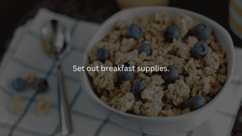 Nightly cleaning routine: set out breakfast supplies. Bowl of granola with blueberries and spoon sitting on table.